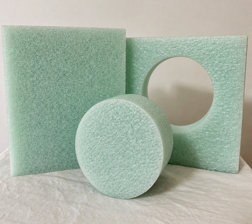 Three views of the Nashmor toilet tank water reducer module on a white fabric surface against a light beige background: .